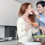 A young couple in their kitchen. She is redheaded and he has brown hair. More images of this lifwstyle series in port, including breakfast time, preparing salad and pasta. Made with professional make-up.